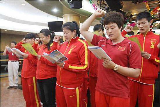 China's Olympic athletes and coaches make a vow before the national flag to reject using banned substances during the London 2012 Games. Chinese atheles vow anti-doping for London Olympics