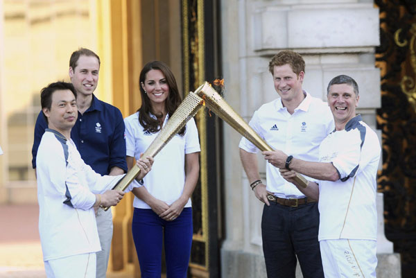 Britain's Prince William, his wife Catherine, Duchess of Cambridge, and Prince Harry show their support to the Games during a visit to Bacon's college to launch the Coach core sports program a day before the London 2012 Olympics opening ceremony in London. British royal family cheers for Olympic Games