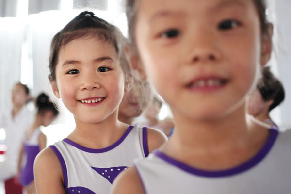 At a children's sports school in Jiaxing, Zhejiang province, girls wait in turn for a gymnastics practice. Shen Zhicheng / for China Daily Future Olympians