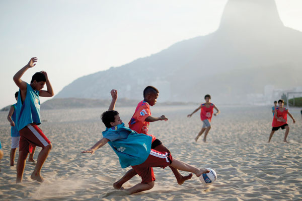 Children play soccer at sunset on Ipanema beach in Rio de Janeiro, Brazil. Christophe Simon / Agence France-Presse Future Olympians