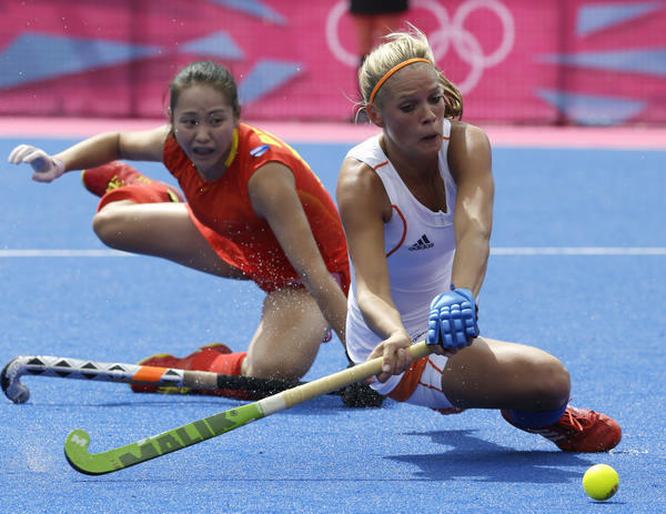 The Netherlands' Ellen Hoog (right) tries to score against China's Ren Ye during the women's hockey preliminary match at the 2012 Olympics on Thursday. The Netherlands won 1-0. Bullit Marquez / Associated Press A Korean coach's Chinese family