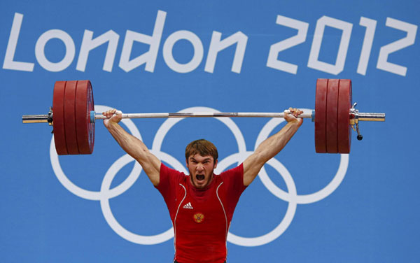 Russia's Apti Aukhadov lifts on the men's 85Kg group A weightlifting competition at the ExCel venue at the London 2012 Olympic Games August 3, 2012. <STRONG>Weightlifting:</STRONG> Rivals chip away at China dominance