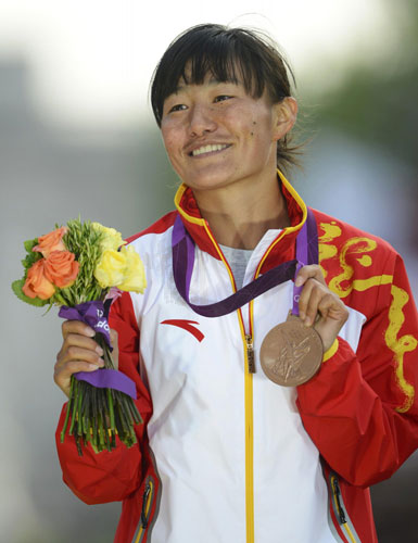 China's Choeyang Kyi holds her bronze medal during the women's 20km race walk victory ceremony at the London 2012 Olympic Games at The Mall August 11, 2012. China cheers for 1st Tibetan Olympic medalist