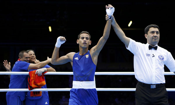 Cuba's Robeisy Ramirez Carrazana is declared the winner over Mongolia's Tugstsogt Nyambayar (not shown) after their Men's Fly (52kg) gold medal boxing match at the London Olympics August 12, 2012. Cuban boxer wins boxing men's 52kg gold medal