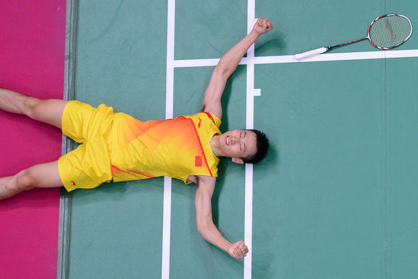 China's Zhang Nan falls to the court after victory in the mixed doubles final badminton match with Zhao Yunlei against teammates Ma Jin and Xu Chen. Victory and spirit