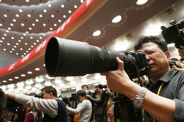 A photographer takes photos of the opening ceremony of the 18th National Congress of the Communist Party of China (CPC) at the Great Hall of the People in Beijing, capital of China, Nov 8, 2012. Journalists cover opening ceremony of CPC congress