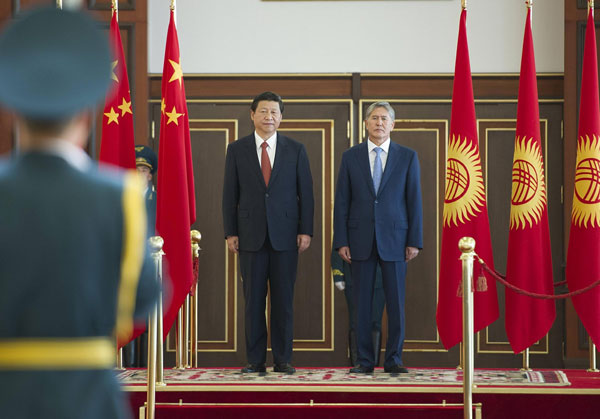 President Xi Jinping, left, attends a welcoming ceremony held by his Kyrgyz counterpart Almazbek Atambaev, right, in Bishkek, Kyrgyzstan, Sept 10, 2013. Xi in Kyrgyzstan for state visit, SCO summit
