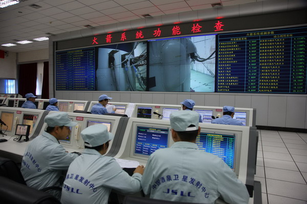 Workers check the Long March-2FT1 carrier rocket in Jiuquan, Northwest China's Gansu province, Sept 21, 2011. China's first space lab module ready for launch