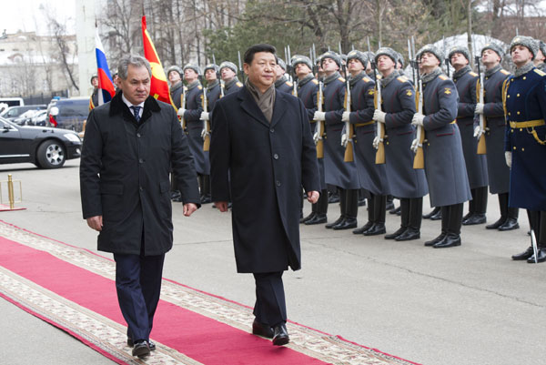 President Xi Jinping (R, Front) inspects the guard of honor together with Russian Defense Minister Sergei Shoigu (L, Front) during a visit to the Russian Defense Ministry in Moscow, the capital of Russia, March 23, 2013. Xi hopes China, Russia to boost military ties
