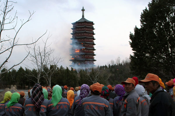 The body of Yongding Tower, an iconic building for the Ninth China (Beijing) International Garden Expo which will be held in May, catches fire in Fengtai district in Beijing at 3 pm on April 8, 2013. Wang Jing/China Daily Beijing's Garden Expo might be delayed after fire