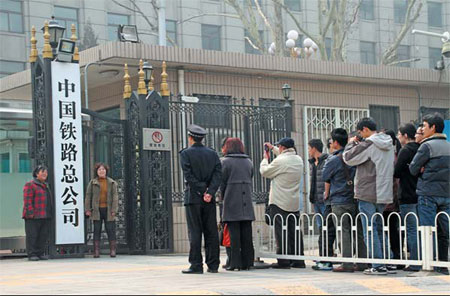 People line up to pose for photographs at the entrance of China Railway Corporation, a company established to take over the commercial duties of the now defunct Ministry of Railways. Provided to China Daily Reorganized railways an engine for reform