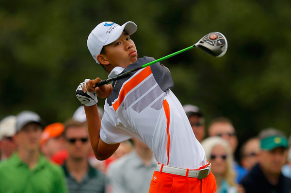 Amateur Guan Tianlang hits his tee shot on the 10th hole during the final round of play at the 2013 Masters. Brian Snyder / Reuters Chinese golfer tees off young career