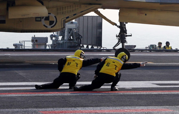 The 'Carrier Style', demonstrated by takeoff assistants, has become a popular feature of Chinese websites. Photos by Li Tang / for China Daily From Gangnam to 'Carrier Style'