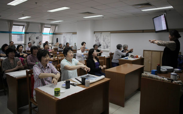Students warm up before their painting class at the university in Haidian. Never too old to learn new tricks