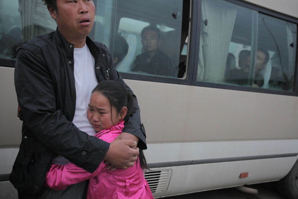 A girl cries after losing her relative in a fire broke out on Monday morning at a poultry factory in Jilin, June 4, 2013. Poultry plant fire death toll rises to 120