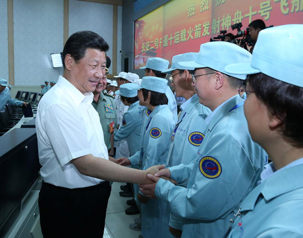 President Xi Jinping (L) meets engineers participating in the Shenzhou-X Manned Spacecraft flight mission at the Jiuquan Satellite Launch Center in Jiuquan, Northwest China's Gansu province, June 11, 2012. President Xi shares his joy with space program staff