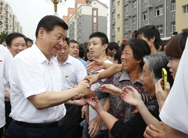 President Xi Jinping (L front), visits residents of Tayuanzhuang Village in Zhengding county, north China's Hebei province, on July 12, 2013. Xi urges CPC members to keep China red