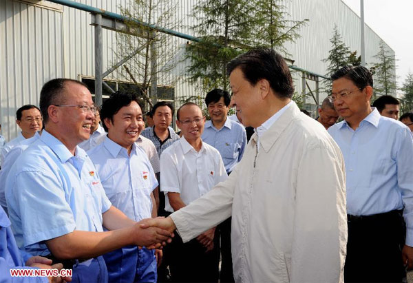 Liu Yunshan (front, R), a member of the Standing Committee of the Political Bureau of the Communist Party of China (CPC) Central Committee, visits the Shijun Zhenxing Automobile Co Ltd in Bijie, Southwest China's Guizhou province, Aug 23, 2013. Senior leader stresses improving CPC work style