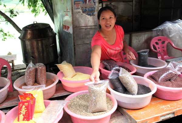 Local resident, Huang Lilin, sells beans, corn, millet, mushrooms and hemp in Longevity village. A county for the ages