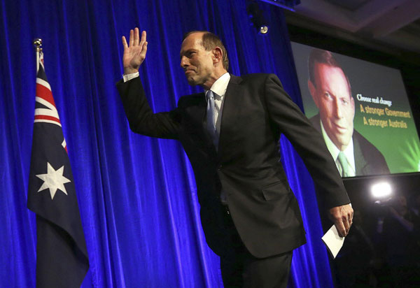 Australia's conservative leader Tony Abbott arrives to the stage to claim victory at an election night function in Sydney September 7, 2013. Premier Li congratulates new Australian PM
