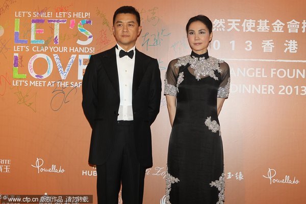 Li Yapeng and Faye Wong take part in a charity activity in Hong Kong, on May 27, 2013. Faye Wong announces her divorce