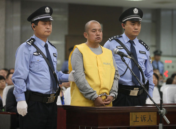 Wang Shujin, a death row prisoner convicted of raping and killing at least four women, stands trial at Handan Intermediate People's Court, in Handan, North China's Hebei province, on Friday. Court upholds serial killer's death sentence