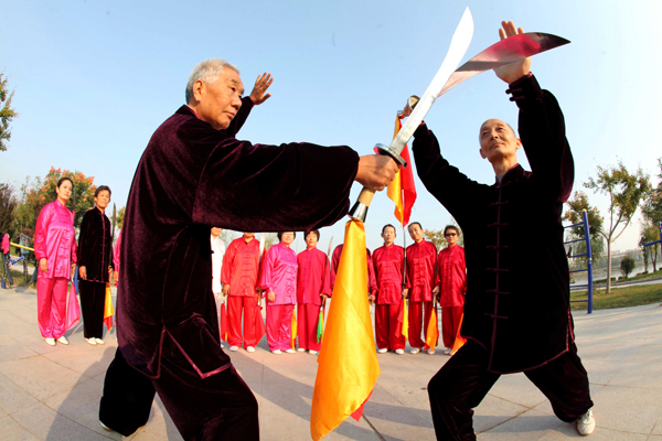 Elderly people exercise at a park in Bozhou, East China's Anhui province, Oct 13, 2013. China embraces first Seniors' Day