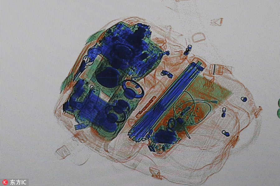 X-ray scanner reveals passangers' luggage for home journey during Spring Festival