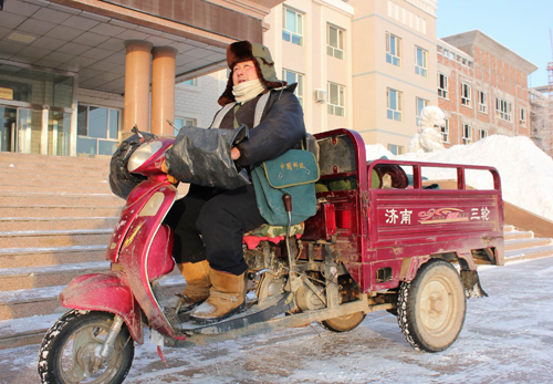 新疆兵團(tuán)六師共青團(tuán)農(nóng)場郵政所郵遞員頂風(fēng)冒雪送郵件