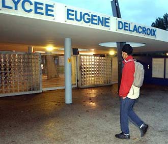 An unidentified Sikh, wearing a head piece instead of a turban, enters his high school in Drancy, outside Paris, early Wednesday Oct. 20, 2004. Some Sikh schoolchildren risk expulsion from their school for wearing their turban. Two Muslim girls who refused to remove their head scarves have been expelled Tuesday in Mulhouse, eastern France, as officials begin taking action against those who defy the new law banning conspicuous religious symbols from public schools. Sign reads: Eugene Delacroix highschool.