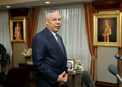 U.S. Secretary of State Colin Powell expresses the sympathy of the American people and President Bush for the loss of life in the tsunami tragedy, as he visits the Embassy of Thailand, in Washington, Thursday, Dec. 30, 2004. He told reporters that in the last 24 hours, a half-dozen planes from the U.S. Agency for International Development have landed or are en route to nations affected by the tsunamis. Behind him are portraits of Thailand's monarchs, King Phumiphon, at far left, and Queen Sirikit. [AP]