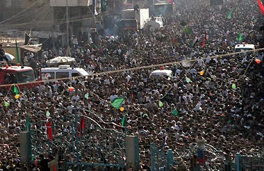 Ambulances remain on standby among the crowd of Iraqi pilgrims near the Kadhimiya mosque in Baghdad August 31, 2005.