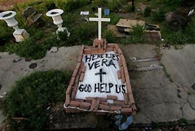A makeshift tomb at a New Orleans street corner conceals a body that had been lying on the sidewalk for days in the wake of Hurricane Katrina on Sunday, Sept. 4, 2005.