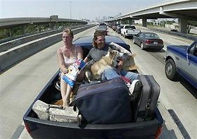 Cherlyn, left, and Lane McWhorter of Baycliff, TX ride in the back of a pickup truck with their animals in Houston, Thursday, Sept. 22, 2005.