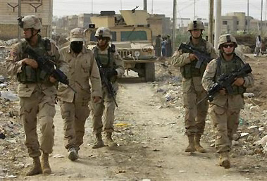 U.S. soldiers from the Third Infantry Division patrol along the airport road in Baghdad, Iraq, Monday, Oct. 31, 2005. Six U.S. soldiers were killed in two bombings on Monday, the military said, making October one of the deadliest months for U.S. troops in Iraq this year. In the worst attack, four Task Force Baghdad soldiers died when their patrol struck a roadside bomb in Youssifiyah, south of Baghdad, according to the military. (AP Photo/Jacob Silberberg