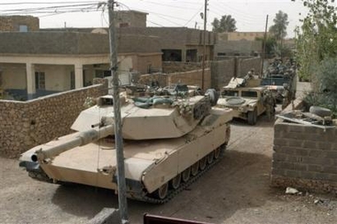 In this picture released by the US Forces, Monday, Nov. 7, 2005, a tank and vehicles of 3rd Battalion, 6th Marines operate as security while Marines and Iraqi Army soldiers clear houses during Operation Steel Curtain, in Husaybah, Iraq. (AP