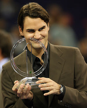 Roger Federer of Switzerland holds the trophy during the crowning ceremony of the year-end No. 1 in Shanghai November 14, 2005. Federer was formally crowned year-end number one for the second year running in a lavish ceremony in Shanghai on Monday.