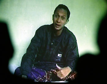 A group of Indonesian Muslim leaders (foreground) watch a video in Jakarta, November 17, 2005, released by police on Wednesday showing one of the Bali suicide bombers. A masked man believed to be one of Asia's most wanted militants, Noordin Mohamad Top, has warned Western countries, especially Australia, of more attacks in a video found last week by Indonesian anti-terrorist police. The video also showed three young suicide bombers who killed 20 people in attacks on restaurants on the resort island of Bali on October 1, 2005. On the tape, one of the three said they would be in heaven once the tape was aired.
