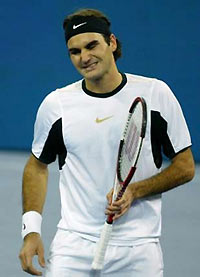 Roger Federer of Switzerland reacts as he misses a shot during his match with David Nalbandian of Argentina at the Tennis Masters Cup final in Shanghai November 20, 2005. 