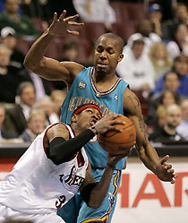 jPhiladelphia 76ers guard Allen Iverson (3) heads for the basket under pressure from the New Orleans /Oklahoma City Hornets forward David West (top) during first quarter NBA action in Philadelphia, November 21, 2005.