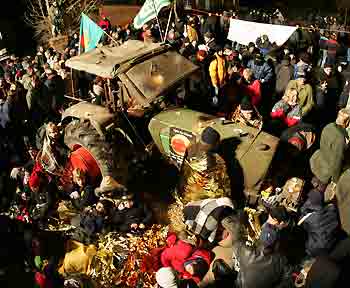 Anti-nuclear protesters surround a tractor where farmers chained themselves on the chassis of a tractor in the small village of Grippel late November 21, 2005, as they block the transport road to the Gorleben interim storage facility. The controversial shipment of twelve Castor containers with spent nuclear fuel arrived in Dannenberg on their way from the French reprocessing plant of La Hague to the Gorleben interim storage facility in northern Germany.