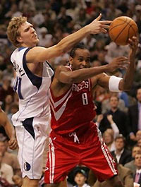 Houston Rockets guard Derek Anderson (8) and Dallas Mavericks forward Dirk Nowitzki, (41) from Germany, reach for a rebound in the fourth quarter of their game in Dallas, Tuesday, Nov. 22, 2005.