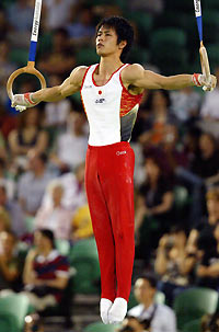 Hiroyuki Tomita of Japan competes in the rings event during the men's all around final at the World Gymnastics Championships at Rod Laver Arena in Melbourne November 24, 2005.
