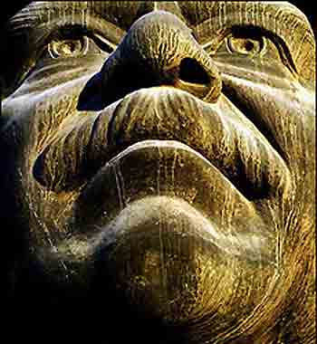 One of the last three giant remaining statues depicting former Iraqi president Saddam Hussein is seen covered with dust and dry mud, at US army base inside Baghdad's heavily fortified Green Zone.