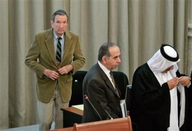 Former U.S. attorney general Ramsey Clark (L) breaks for a lunchtime court recess during Saddam Hussein's trial in Baghdad November 28, 2005.