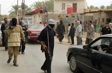 Hooded men carrying assault rifles check passing cars in Ramadi, Iraq Monday, Dec. 12, 2005, ahead of the Dec. 15 parliamentary elections, which will select a National Assembly that will serve for four years.