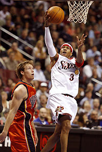 hiladelphia 76ers guard Allen Iverson (3) goes for the basket past the Golden State Warriors forward Mike Dunleavy during first quarter NBA action in Philadelphia December 21, 2005.