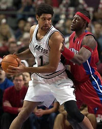 San Antonio Spurs' Tim Duncan, left, prepares to drive to the basket against Detroit Pistons' Ben Wallace during the first half of their NBA basketball game on Sunday afternoon, Dec. 25, 2005, in Auburn Hills, Mich.