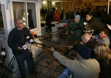 Omri Sharon, left, the son of ailing Israeli Prime Minister Ariel Sharon, reads a statement to members of the media outside the Hadassah hospital in Jerusalem, where his father remains in critical condition, Tuesday Jan. 10, 2006.