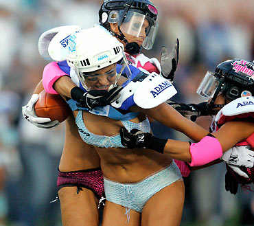Los Angeles Temptation(blue) play against New York Euphoria during the third annual Lingerie Bowl football game in Los Angeles February 5, 2006. The 30-minute game features models playing full-contact football in lingerie and airs locally on pay-per-view during half time of the NFL's Super Bowl XL football game.